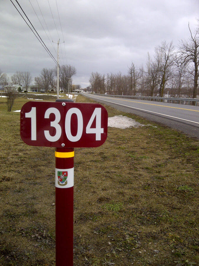 A civic number posted at the roadside